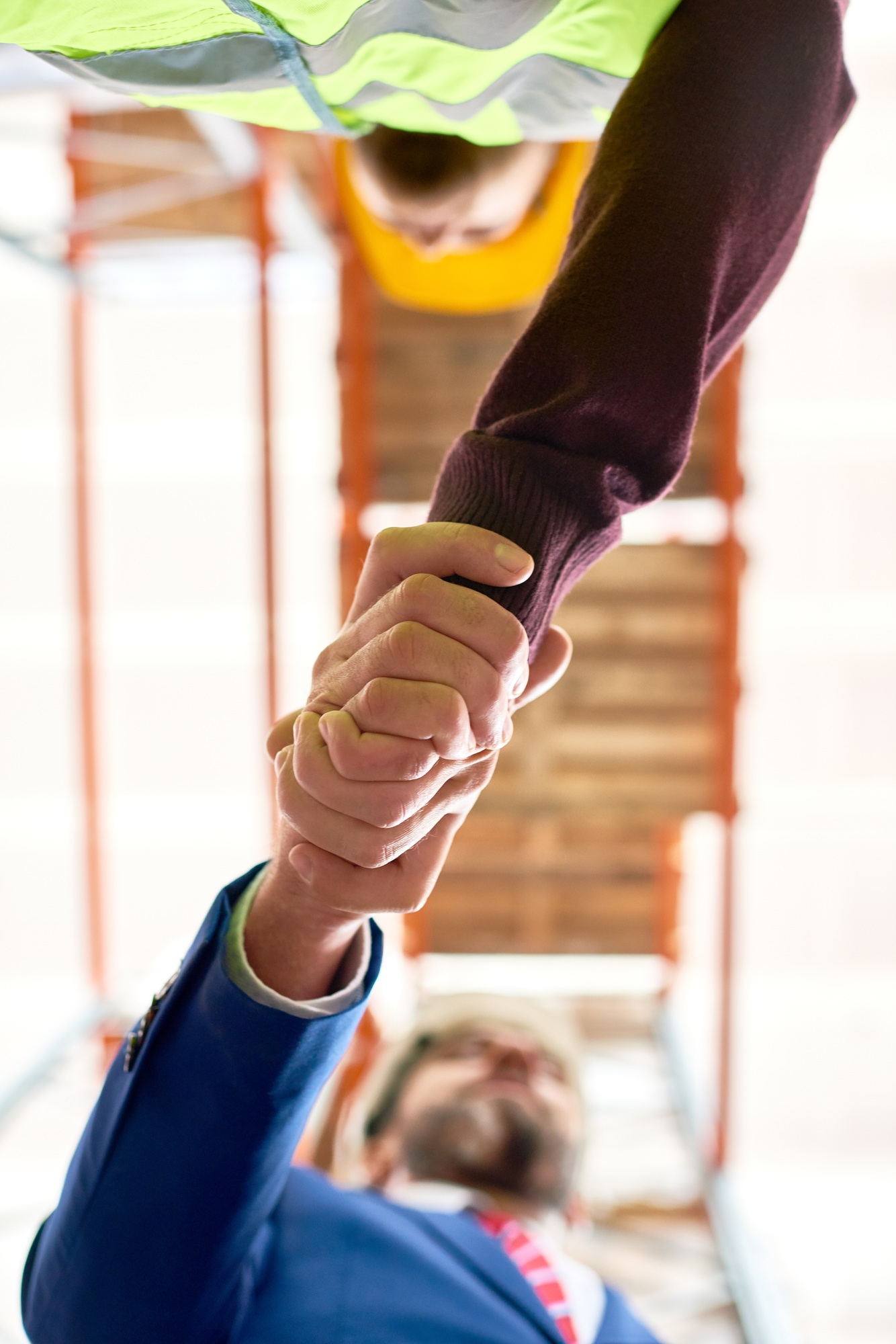Businessman Shaking Hands with Worker