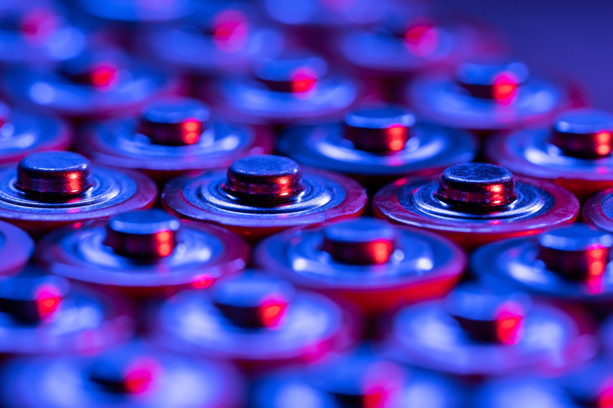 Closeup of positive ends of discharged batteries AA sizes, macro shot, selective focus. Used battery